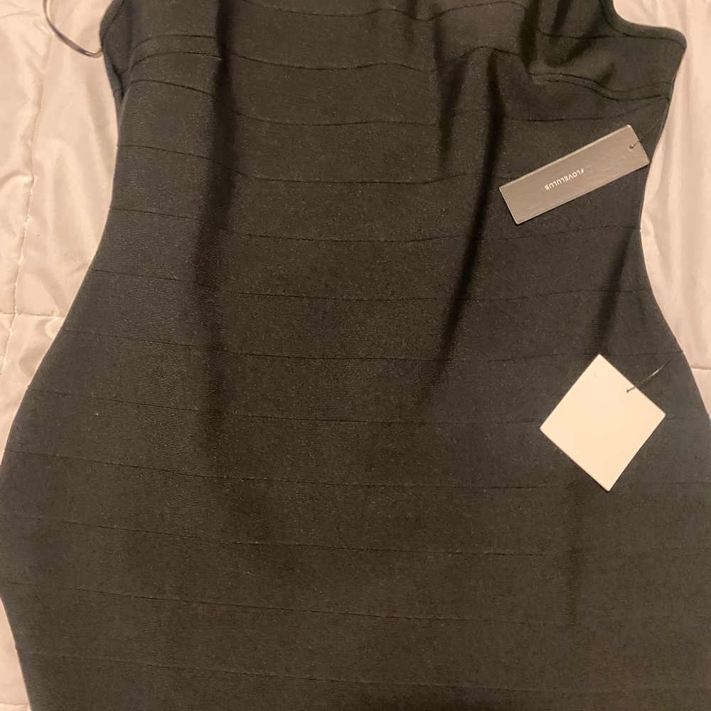 Black bodycon dress with tassels. Bought last year and never worn.